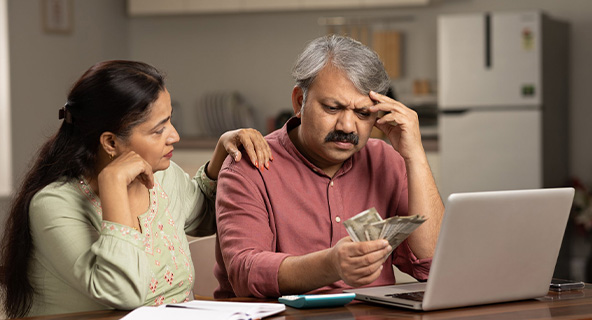 Indian family looking worried about rising costs and inflation, financial stress concept